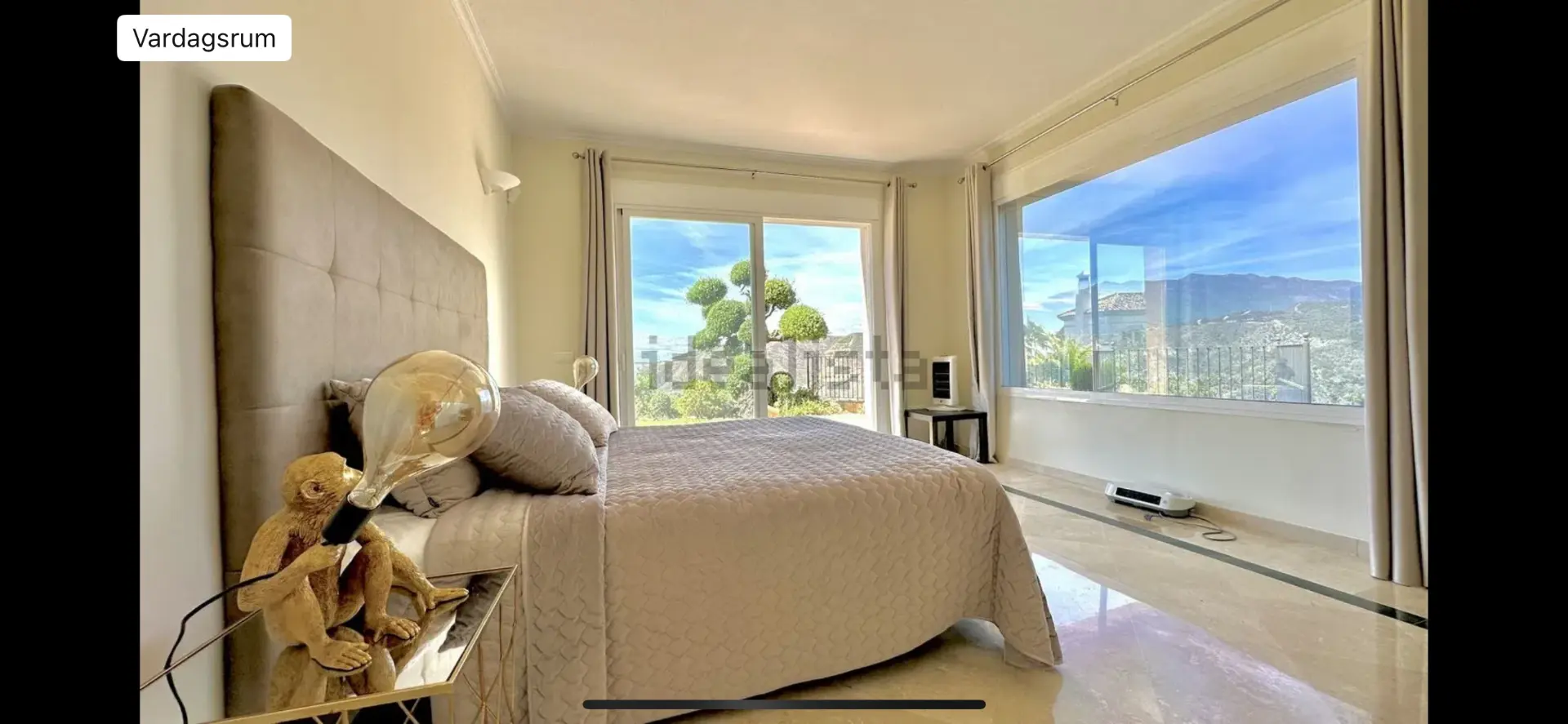 Spacious camp bedroom with panoramic mountain views