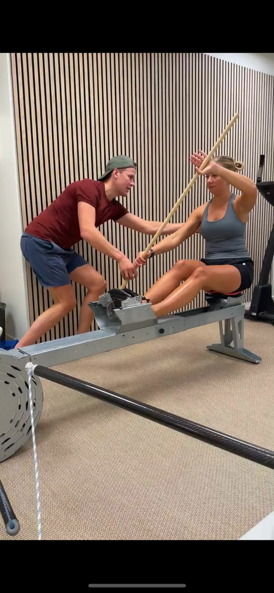 Joakim Lindberg coaching a paddler on the rowing ergometer